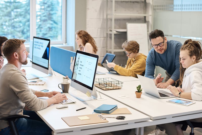 Diverse team working together at computers in a modern office